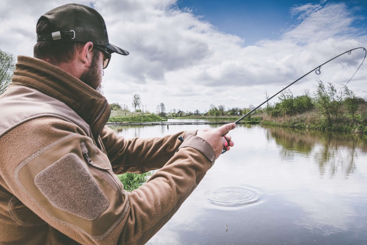 A man on a Minnesota lake trying to catch a fish.