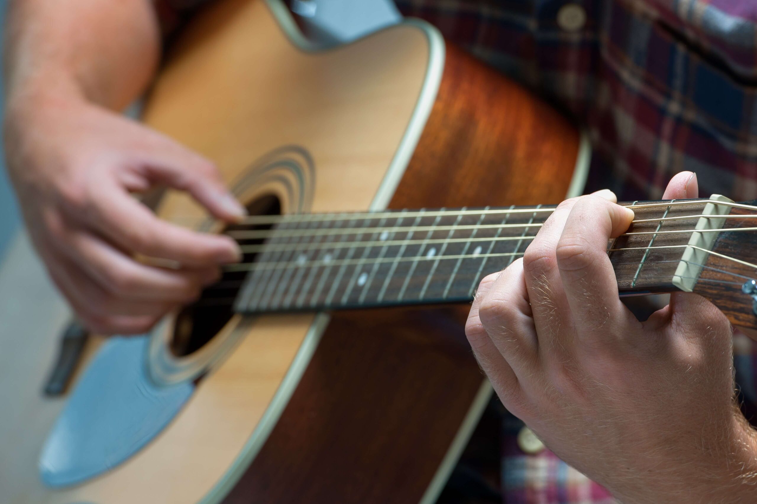 A close up picture of a man playing a guitar at Events Walker, MN.