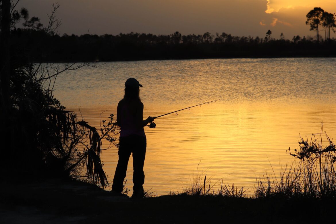 A person fishing on the Best Fishing Lakes In Minnesota.