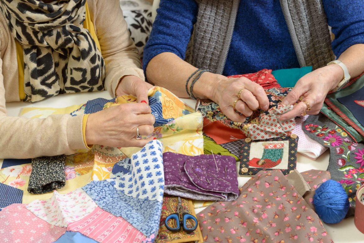 Some women working on a Quilted Blanket.
