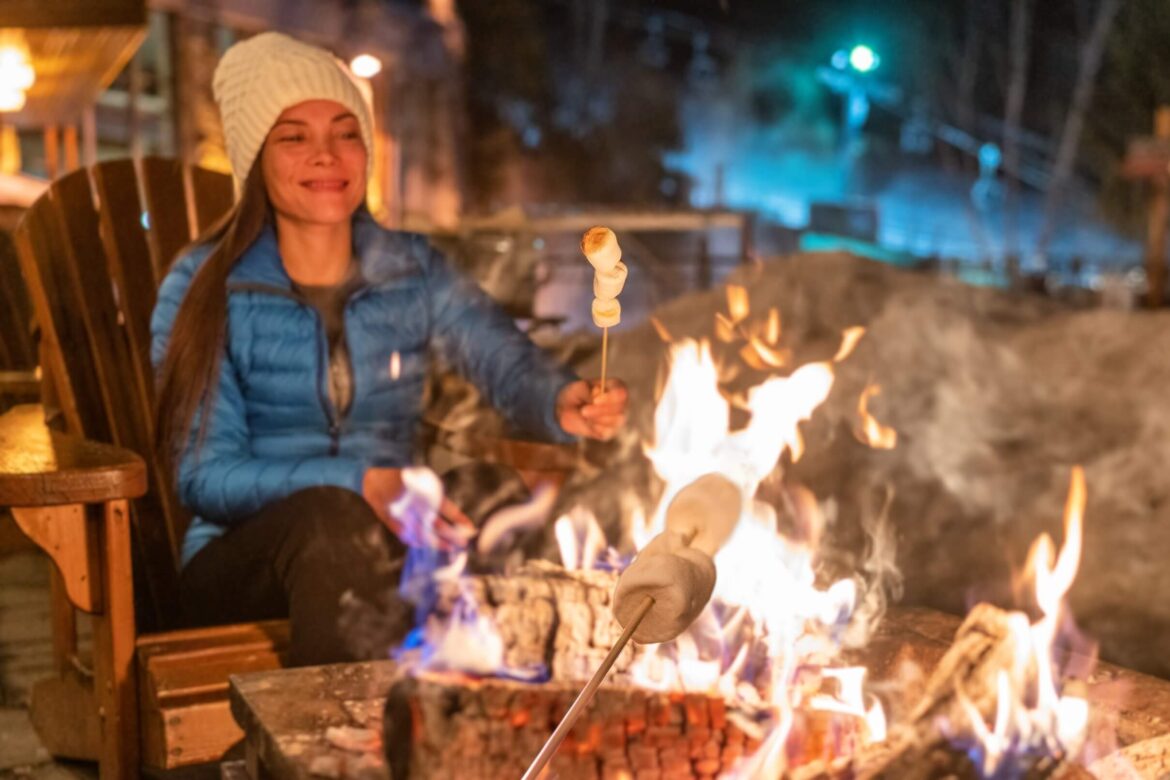 A woman enjoying a Hunter's Widow weekend by the campfire.