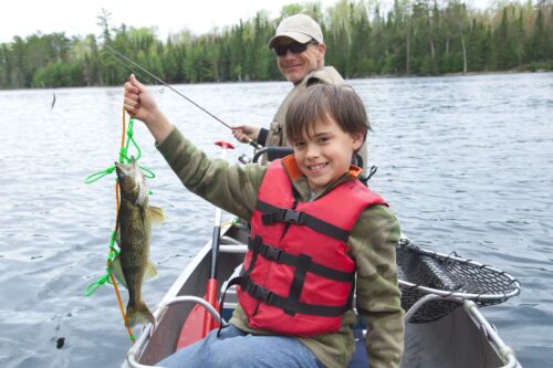A man and a boy fishing during Minnesota Fishing Opening.