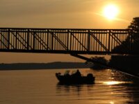 A person in a boat on Leech Lake near Hackensack, Minnesota, at sunset.
